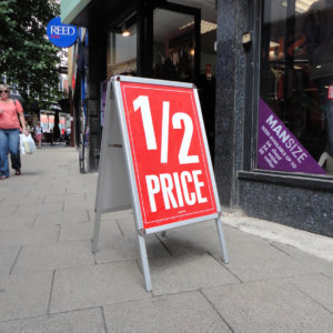 Image of the a master a board outside a shop front with a poster in place