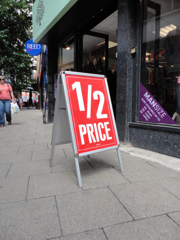 Image of the a master a board outside a shop front with a poster in place