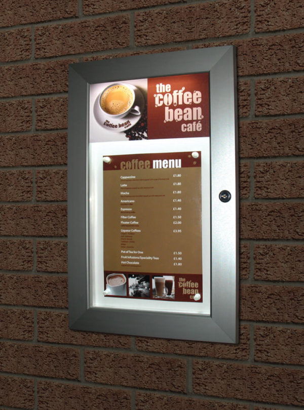 An illuminated menu display case mounted on a wall with display menu in place