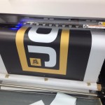 A photo of a 17m mesh banner being printed for Grassland and Muck