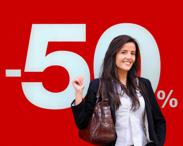 A picture of a lady stood in front of a large format printed card POS sign