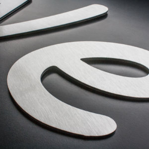 Dibond flat cut letters in a butler (brushed aluminium) finish