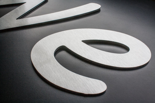 Dibond flat cut letters in a butler (brushed aluminium) finish